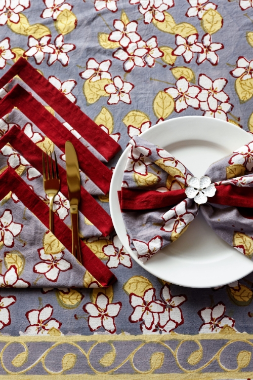 Artisan table textiles featuring hand-printed floral motifs